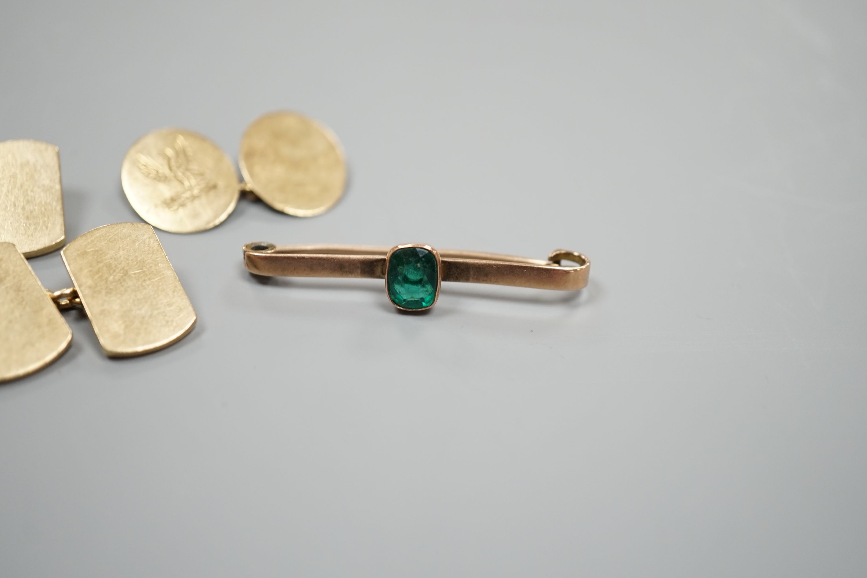 A pair of 9ct gold cufflinks, one other single 9ct gold cufflink and a 9ct and gem set bar brooch